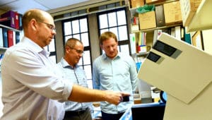 David Edgell, PhD, Greg Gloor, PhD, and Bogumil Karas, PhD using one of Canada's only DNA printers in their lab at Western