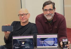 Tim Bussey and Marco Prado infront of computer screens showing the mousebytes platform